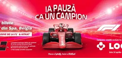 Red Formula 1 car racing on a track with a KitKat and F1 promotion for winning tickets to the Spa, Belgium race.