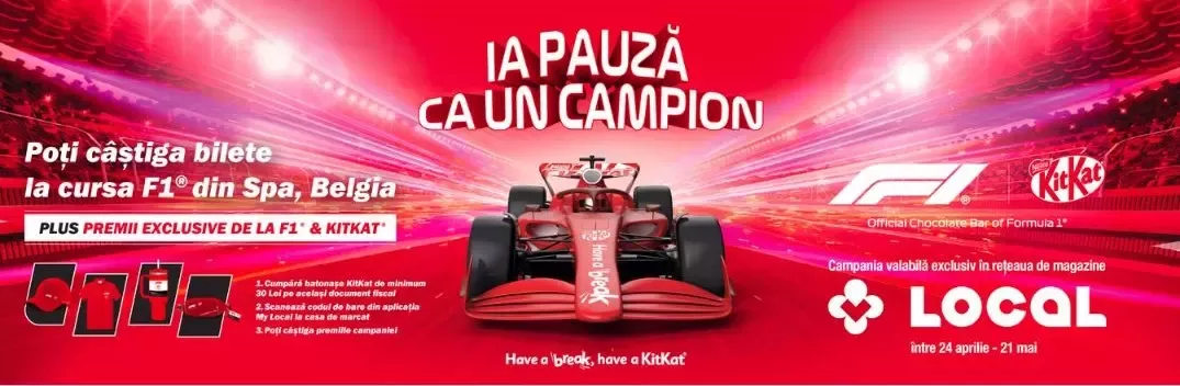 Red Formula 1 car racing on a track with a KitKat and F1 promotion for winning tickets to the Spa, Belgium race.